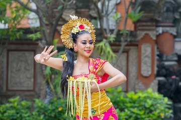 Attractive Balinese dancer showing a dance