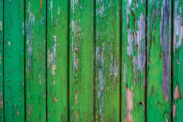Fototapeta na wymiar Wooden planks with peeling old green paint