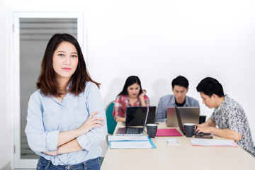 Fototapeta premium Confident female entrepreneur near her business team