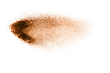 Fototapeta premium Abstract brown color sand splash on white background. Brown dust particles explosion on background, throwing freeze stop motion concept.