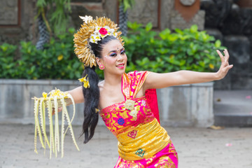 Female Pendet dancer showing a dance at outdoor