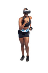 Black African American female running in VR while wearing a virtual reality headset for training or playing a video game.  Depicts technology and sport and esports.
