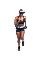 Black African American female running in VR while wearing a virtual reality headset for training or playing a video game.  Depicts technology and sport and esports.