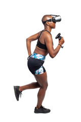 Black African American female running in VR while wearing a virtual reality headset for training or playing a video game.  Depicts technology and sport and esports.