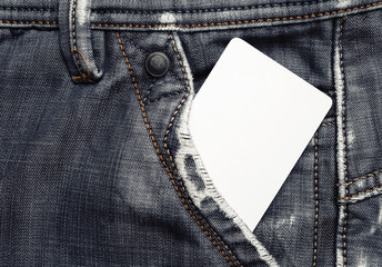 Blank credit card card in gray jeans pocket. White plastic chip card.