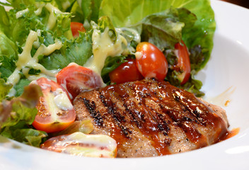 Grilled steaks, and vegetable salad