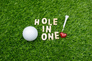 Golf hole in one with love on green grass