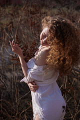 Beautiful curly girl in white lingerie. Outdoor photography