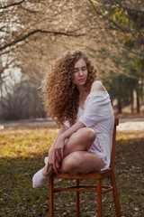 Beautiful curly girl in white lingerie. Outdoor photography