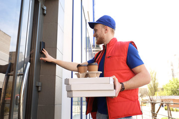 Portrait of courier with order at door. Food delivery service
