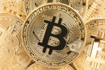 Shiny gold bitcoins as background, closeup view. Digital currency