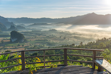 Fototapeta premium A beautiful morning fog scenery in the bamboo balcony with mountain background. Start new day with the nice view. Fresh Days.