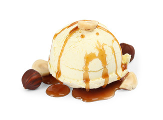 Delicious ice cream with caramel sauce and hazelnuts on white background