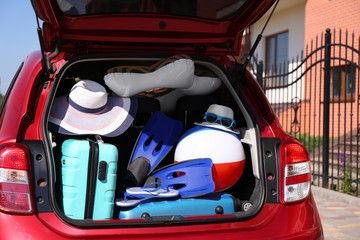 Family car with open trunk full of luggage outdoors, closeup
