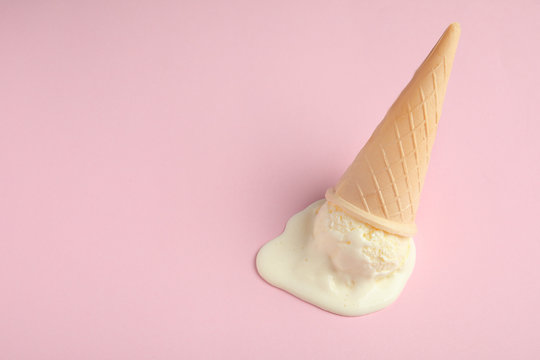 Melted Vanilla Ice Cream In Wafer Cone On Pink Background, Above View. Space For Text