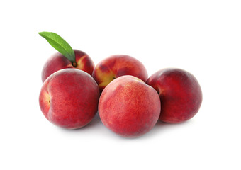 Delicious ripe peaches with leaf isolated on white
