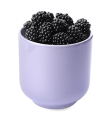 Purple cup of tasty blackberries on white background