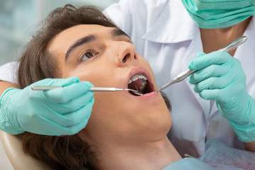 Handsome young man sitting with an open mouth