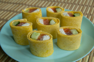 Cheese cake roll with salmon, curd cheese and cucumber