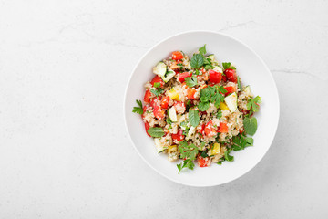 Quinoa tabbouleh  salad with fresh tomatoes, cucumbers and fresh greens.