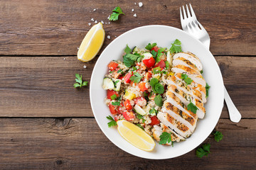 Fresh quinoa tabbouleh salad with grilled chicken.
