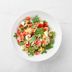 Quinoa tabbouleh  salad with fresh tomatoes, cucumbers and fresh greens.