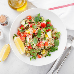 Quinoa tabbouleh  salad with fresh tomatoes, cucumbers and fresh greens.