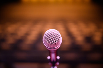Microphone over the blurred business forum Meeting or Conference Room Concept, Blurred background.