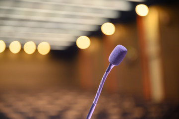 Microphone over the blurred business forum Meeting or Conference Room Concept, Blurred background.