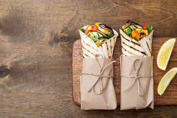 Vegan tortilla wrap, roll with grilled vegetables.