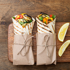 Vegan tortilla wrap, roll with grilled vegetables.