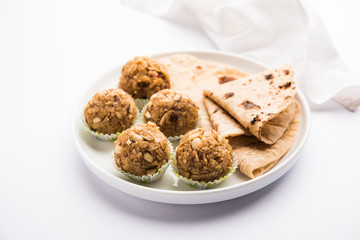 Leftover chapati Laddu / Churma Laddoo or Policha Ladu made with Roti, peanuts, dry fruits and jaggery. selective focus 