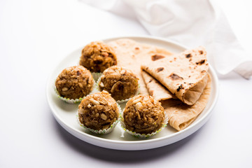 Leftover chapati Laddu / Churma Laddoo or Policha Ladu made with Roti, peanuts, dry fruits and jaggery. selective focus 