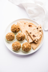 Leftover chapati Laddu / Churma Laddoo or Policha Ladu made with Roti, peanuts, dry fruits and jaggery. selective focus 