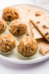 Leftover chapati Laddu / Churma Laddoo or Policha Ladu made with Roti, peanuts, dry fruits and jaggery. selective focus 