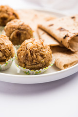Leftover chapati Laddu / Churma Laddoo or Policha Ladu made with Roti, peanuts, dry fruits and jaggery. selective focus 