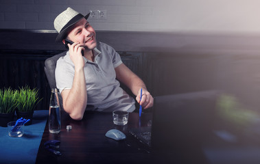 man at table and working on laptop