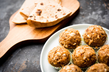 Leftover chapati Laddu / Churma Laddoo or Policha Ladu made with Roti, peanuts, dry fruits and jaggery. selective focus 