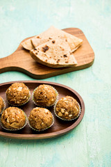 Leftover chapati Laddu / Churma Laddoo or Policha Ladu made with Roti, peanuts, dry fruits and jaggery. selective focus 