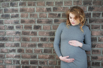 Pregnant young and beautiful girl in a home