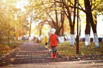 Children walk in the autumn park