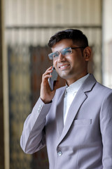 Young Indian Man Wearing Suit And Using Smartphone