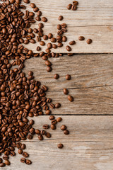 Coffee beans on an old wooden table.