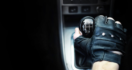 Gear lever. Manual Transmission. Hand on the gear shift in the car.