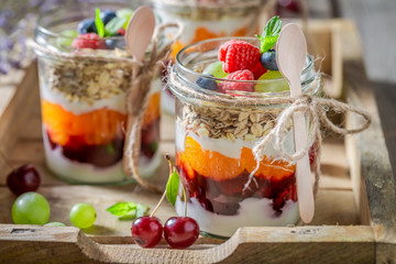 Homemade granola in jar with yoghurt and fresh berries