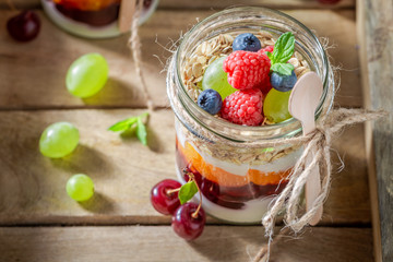 Healthy oat flakes with fresh berries and yoghurt in jar