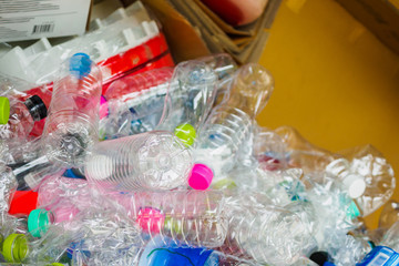 plastic bottles and cardboard paper in recycle trash station close up