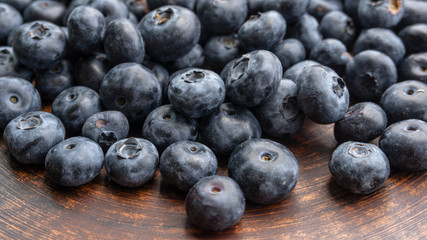 Blueberries and blueberries on the background of pottery. Black berries.