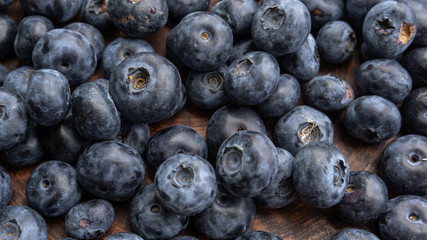 Blueberries and blueberries on the background of pottery. Black berries.