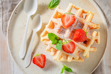 Fresh wafers with sweet strawberries and powdered sugar